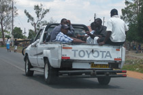 People in the back of a truck - a typical scene.